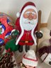 Collection Of Christmas Decorations Featuring Hand Carved Wooden Santa
