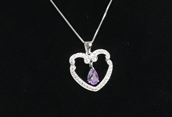 Pear Shaped Amethyst Hanging From Textured Silver Heart