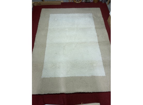 AREA RUG  CREAM WITH TAN BORDER  -APPROX. 7.5' X 10'