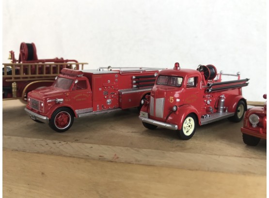 Four Die Cast Firetrucks Of Different Eras