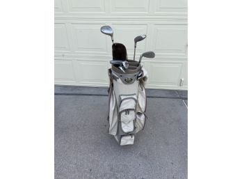Light Colored Wilson Golf Bag With Assortment Of Clubs