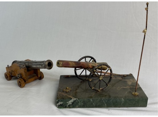 Two Miniature Decorative Cannons, One With Wooden Cart & Other With Granite Slab