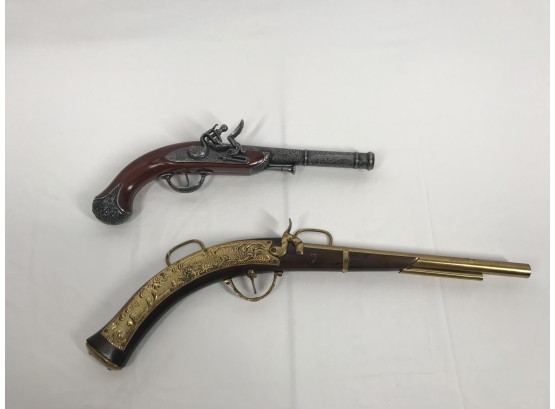 Ornate Replicas Of Antique Pistols With Metal Engraving