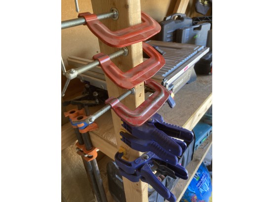 Collection Of Clamps Including Red C Clamps & Blue Squeeze Clamps (Clamps In Foreground Of Photo)
