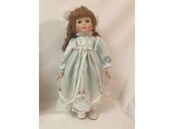 Vintage Doll In Light Blue Dress With Violet Bow