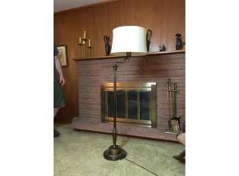 Brass Swing Arm Floor Lamp With Light Colored Lamp Shade