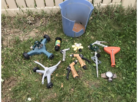 Assortment Of Sprinklers And Hose Attachment Sprayers In Broken Blue Bucket