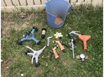 Assortment Of Sprinklers And Hose Attachment Sprayers In Broken Blue Bucket