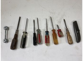 Assortment Of Miscellaneous Screwdrivers, Handy Multi Size Wrench Tool, And Utility Knife