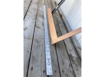 Three Handy Measuring Devices Including A Square, Level, And Metal Yard Stick