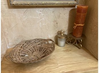 Two Candles, Metal Candle Stand, And Small Wicker Basket