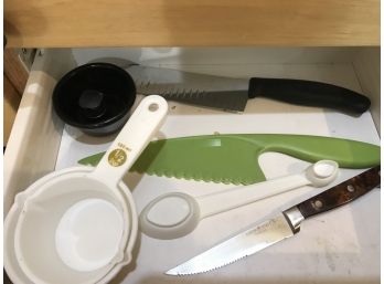 Contents Of 2 Kitchen Drawers Featuring Plastic Measuring Cups, Cutlery And More (see Photos)