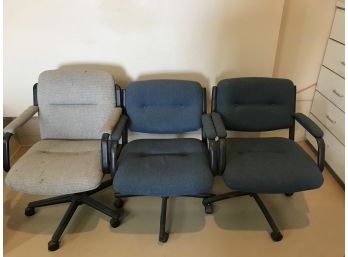 Three Office Chairs, Two Blue And One Gray