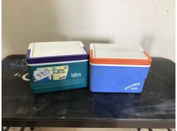 2 Igloo Brand Six Pack Coolers, One Blue And Orange The Other Green And Purple