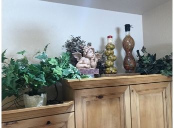 Right Upper Cabinet Decorations Featuring Thinking Angle Statue, Decorative Olives And Faux Vines