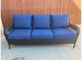 Nice Brown Woven Outdoor Three Seat Couch With Blue Pads And Pillows