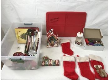 Four Christmas Stockings, A Box Of Ornaments, And Other Decorations