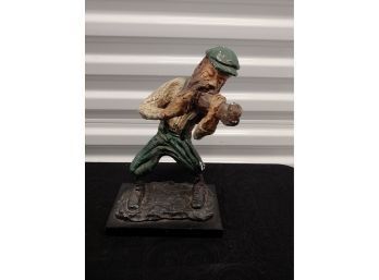 Figurine Of Man Playing Instrument