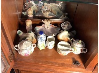 Shelf Of  Collectible Figurines And Dishes