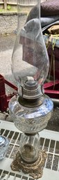 Vintage Oil Lamp With Clear Font And Tall Chimney And Cast Base