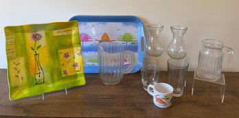 Glass Carafes, Pitcher, One Plastic Pitcher, 2 Melamine Trays, And Vintage Peco Dinosaur Cup.