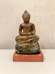 Marble Buddha Statue On A Wood Stand