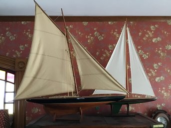 Two Models Of Sailboats On Stands