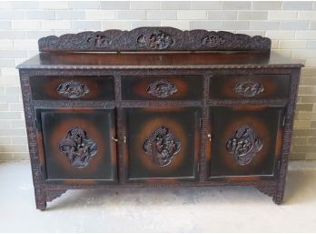 Oriental Style Sideboard Having A Profusely Carved Backsplash Decorated With Flowering Trees