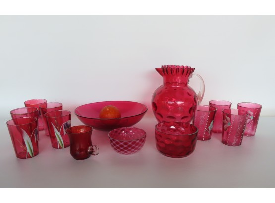 A Grouping Of 15 Pieces Of Cranberry Glass, Most With Edge Chips. Includes 8 Water Glasses With Enameled Decor