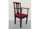 A Chippendale Mahogany Child's Chair Having A Pierced Carved Back, Scrolled Arms, And Chamfered Square Legs, 1