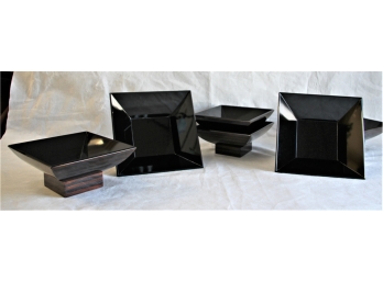 Group Of Six Black Square Dishes On  Wood Bases