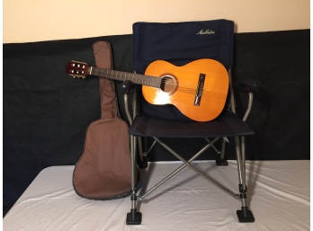 Padded Arm Folding Chair And Guitar