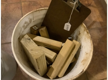 White Bucket With Wood Pieces And Clipboard