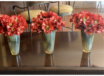 A Trio Of Glass Vases With Faux Flowers