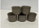 (5) STONEWARE LIBATION CUPS AND “M” SIGNED POTTERY POURING VESSEL