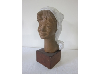 Clay Sculpture With A White Glaze Hat.