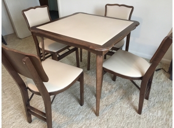 Four Folding Chairs And A Folding Table