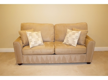 Lovely Tan Upholstered Sleeper Sofa With Two Accent Pillows