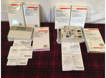 Three Honeywell Programable Thermostats And Four Heat Pump Sub-Base Units
