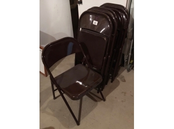 A Set Of Nine Brown Metal Folding Chairs