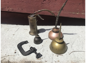 Four Oil Cans And A 'C' Clamp