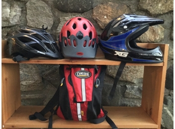 Three Sporting Helmets And Rocket Camelback