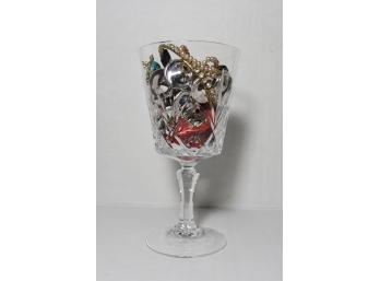 A Glass With Class  A Crystal Glass Filled With Several Pieces Of Jewelry