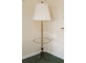 A Brass And Round Glass Shelf Lamp Table
