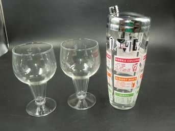 Vintage Drink Shaker With Cocktail Recipes On Exterior & Couple Of Glasses