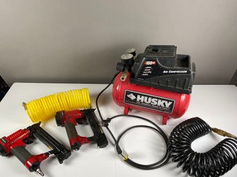 Husky 2-gallon, 100 Max PSI Air Compressor, Two Pneumatic Brad Nailers Or Guns, And Extra Hoses