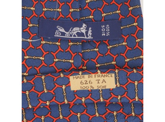 AUTHENTIC HERMES MADE IN FRANCE MENS SILK TIE IN NAVY GROUND WITH RED GOLD HORSEBIT LINKED GEOMETRIC 626 TA