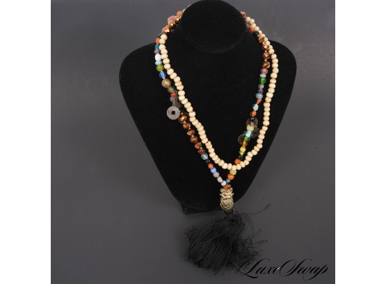 A HIGHLY ORNATE RAINBOW BEADED NECKLACE WITH BRASS CHARMS AND PINEAPPLE AND BLACK TASSEL PENDANT