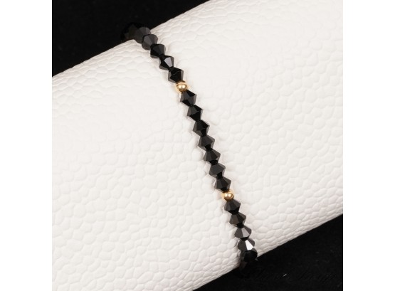 A GORGEOUS BLACK FACETED CRYSTAL BEAD BRACELET WITH TESTED 14K YELLOW GOLD BALLS AND CLASP