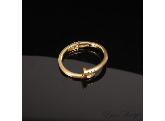 #7 A RECENT AND HIGH QUALITY GOLD TONE BRACELET IN THE SHAPE OF A LARGE NAIL WITH FLEX HINGE